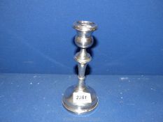 A silver candlestick, Birmingham 1919, makers 'M&J' (Marson & Jones). Some dents, 7" tall, 278g.