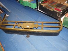 A brass and metal fender 46" x 13"