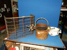 A brass and wire mesh fire guard ( 22'' wide x 11'' deep x 16 1/2'' tall) and brass companion set