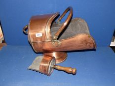 A copper coal scuttle and shovel with wooden handle.