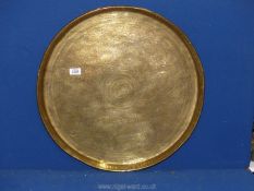 A large brass charger with stylised beasts engraved detail, 23'' diameter.