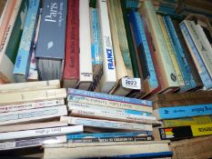 A box of French reference books.