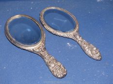 Two heavily embossed Silver hand mirrors one Chester 1899 by William Neale,