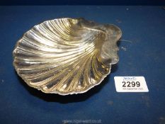 A silver Shell dish on three feet, London 1893, makers mark indistinct (GM?) 74g.