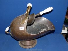 An old copper helmet shaped coal scuttle and shovel with ceramic handles.