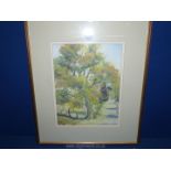 A framed and mounted watercolour depicting a country landscape with a path meandering down a tree