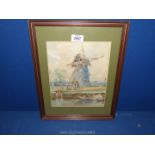 A framed and mounted watercolour depicting a windmill by a canal with barges,