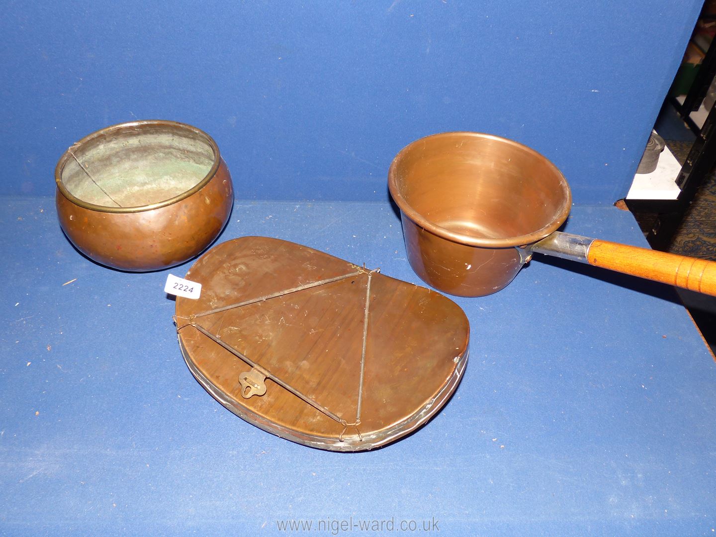 Three pieces of copper including a Belly Warmer hot water bottle, saucepan and bowl.