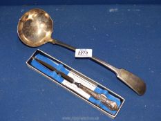 A stainless steel Sterling silver boxed paper knife together with a large plated ladle.