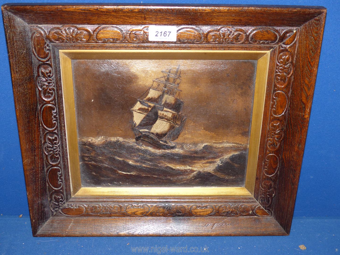 A carved wooden framed Oil on canvas depicting a sailing vessel on high seas in brown tones, - Image 2 of 2