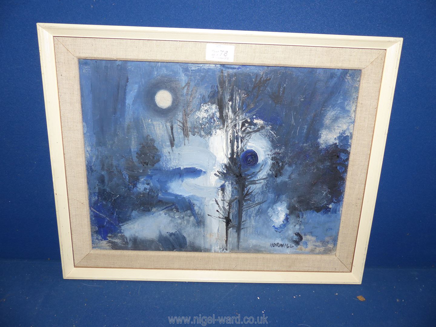 A framed oil on canvas of a Moonlit landscape in blue tones, signed lower right Horwill,