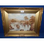 An ornate gilt framed watercolour depicting a Welsh landscape depicting a rocky stoned river with