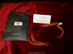 A three strand 'Mikotajczyki Amber Group' necklace in a Boruni bag.