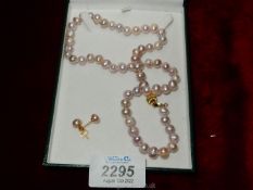 A pearl necklace and earrings set.