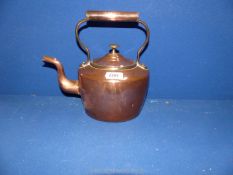 An oval shaped copper kettle.