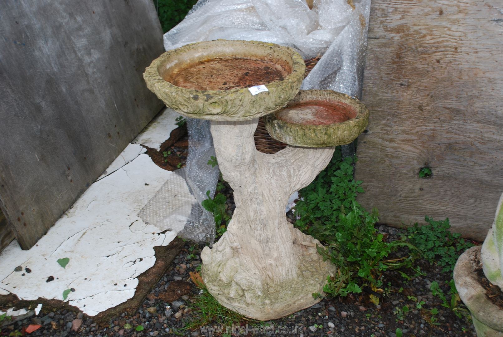 A concrete tree trunk style Bird Bath, 26'' high.