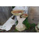 A concrete tree trunk style Bird Bath, 26'' high.