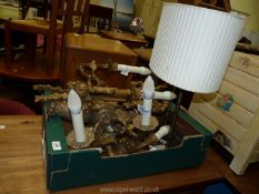 A quantity of wall lights and a table lamp.