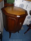 An octagonal drinks cabinet with leather insert to top.