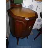 An octagonal drinks cabinet with leather insert to top.