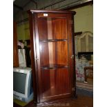 A dark wood corner display cabinet.