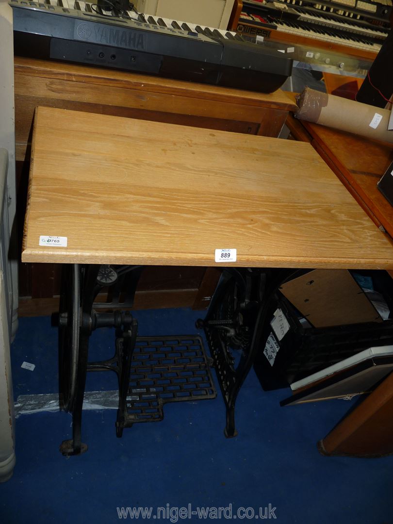 An occasional table with cast iron 'Pheonix' sewing treadle base, 30" x 27" x 18".