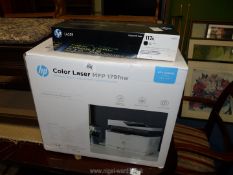 An HP colour laser printer and toner cartridge.