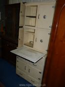 A cream painted retro kitchen unit with slide out enamel work surface,