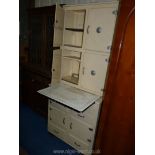 A cream painted retro kitchen unit with slide out enamel work surface,