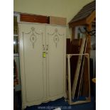 A pair of cream painted wardrobes, one dismantled, 76" high x 42 1/2" wide x 22" deep.