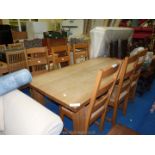 A farmhouse Kitchen Table and set of six rush seated chairs.