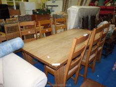 A farmhouse Kitchen Table and set of six rush seated chairs.