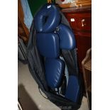 A fold up massage chair in carrier.