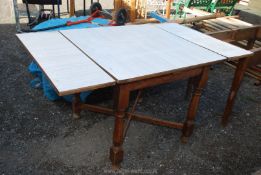 An extending Formica topped table 5' x 3'.