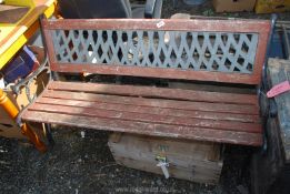 A garden bench with cast ends, 4' wide.