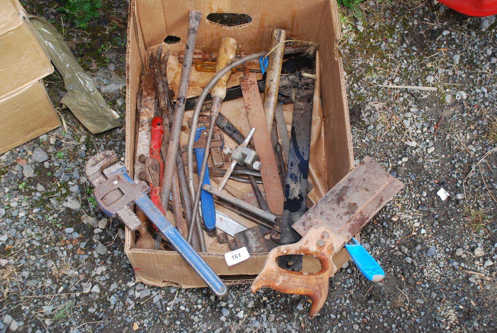 A box of nail bars, Stilsons, saw, set square and various other tools.