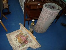 A wooden towel rail, glass table lamp, wall hanging and 2 rugs.