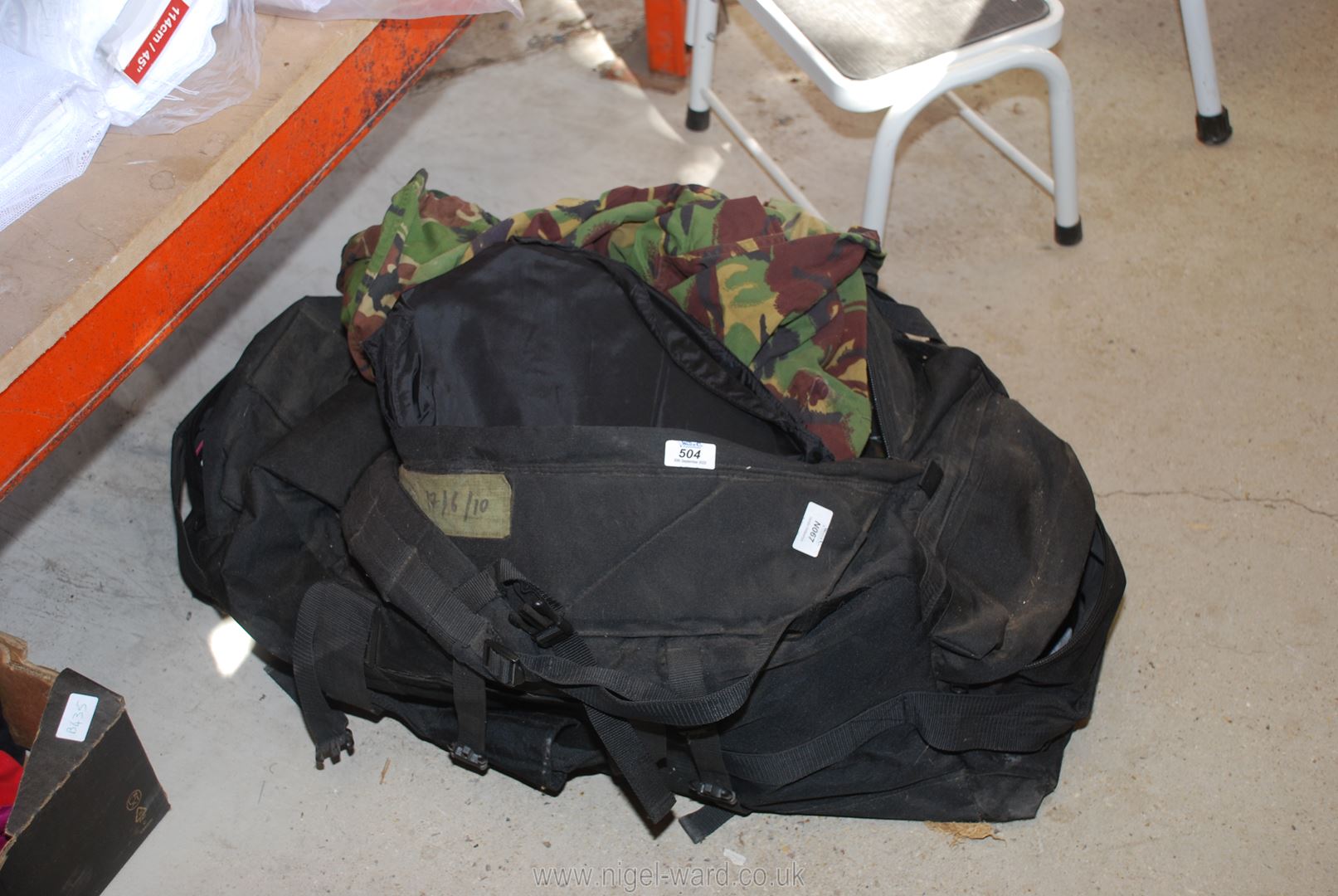 Camouflage clothing in a large holdall, etc.