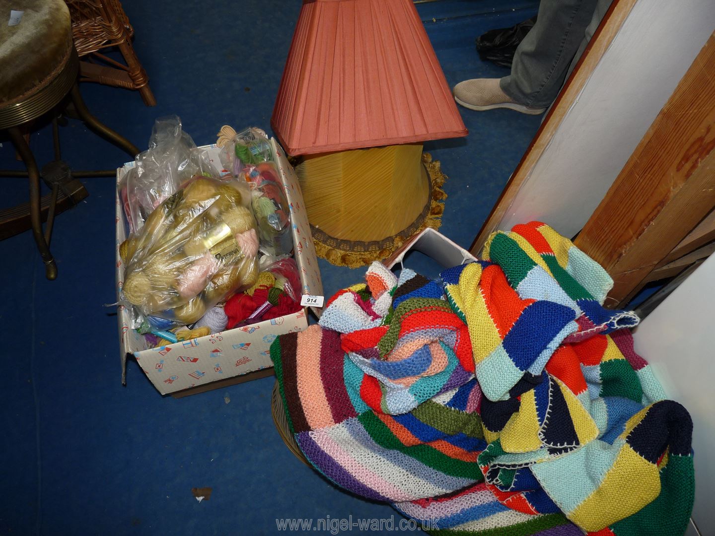 A quantity of lamp shades, knitting wool and two knitted patchwork throws.