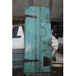 An old blue painted Door with blacksmith hinges, 28 11/2'' wide x 70'' high.