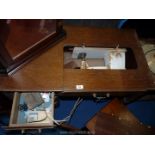 A sewing machine table with Singer sewing machine in compartment a/f.
