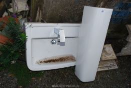 A hand wash basin and pedestal with waterfall tap.