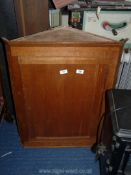 A pine corner cupboard.