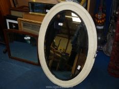 An oval cream painted bevelled Mirror, plus one other.