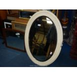 An oval cream painted bevelled Mirror, plus one other.