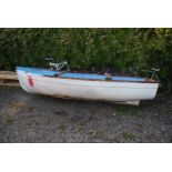 "Hit Mouse", a glass fibre boat/dinghy with three seats including the helmsman's at the stern,