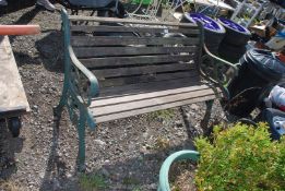 A wooden bench with cast iron ends, 50" wide.