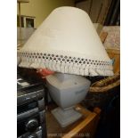 A large cream table lamp and shade.