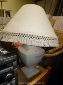 A large cream table lamp and shade.