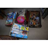 A box of games, giant puzzles and action man figures.